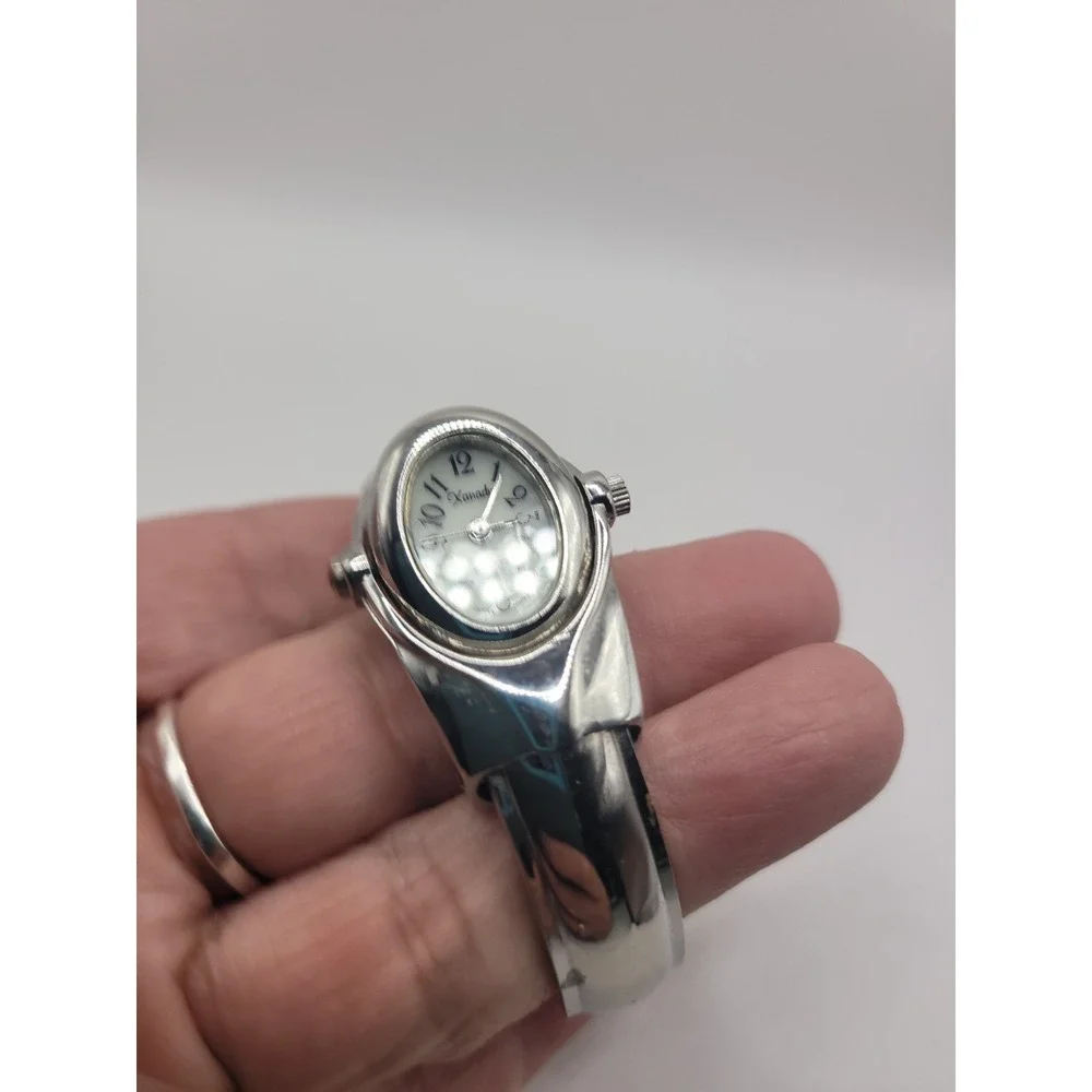Xanadu Women's Silver Tone Hinged Cuff Bangle Quartz Watch Oval Dial Reverse